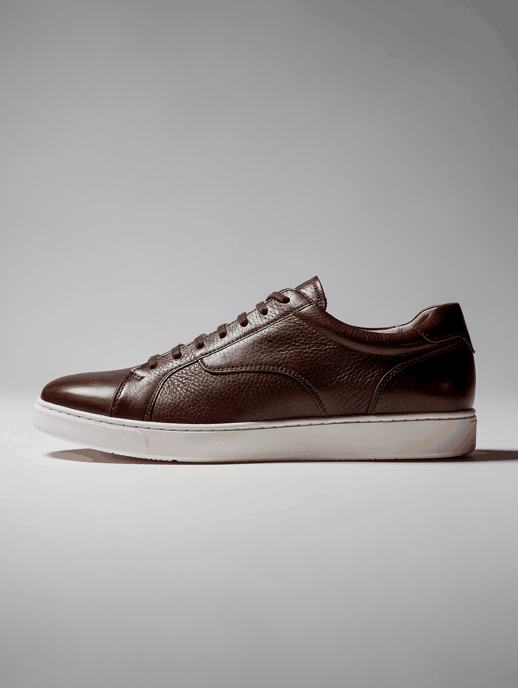 Premium leather sneakers on gallery pedestal